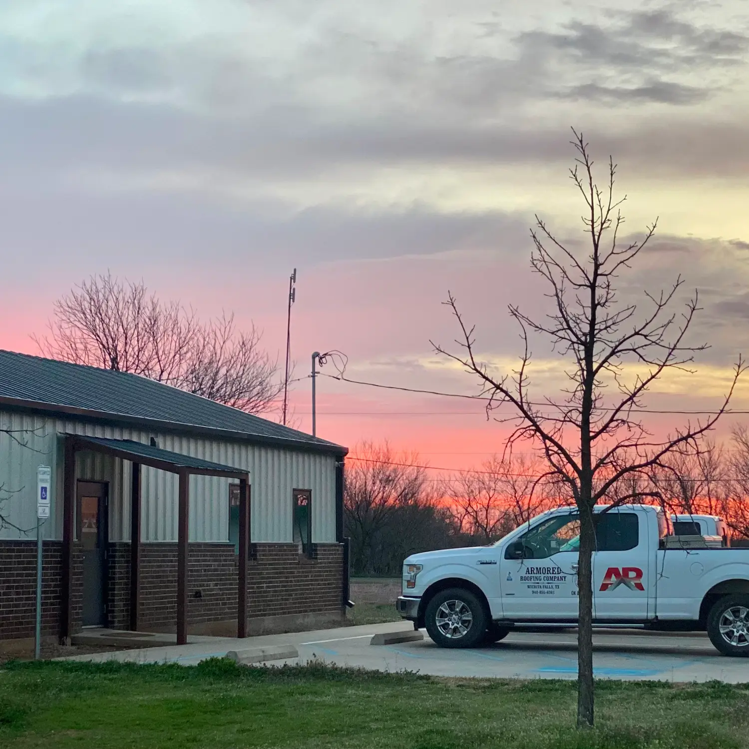 Sunset with armored roofing HQ in foreground.
