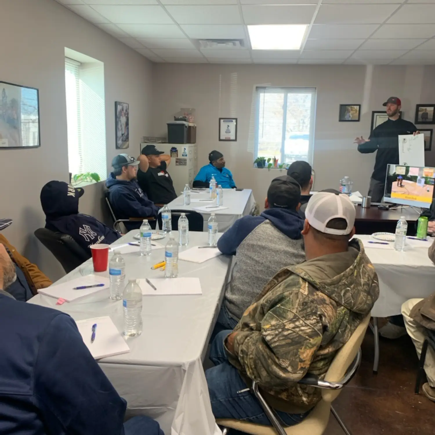 Man giving roofing product training.